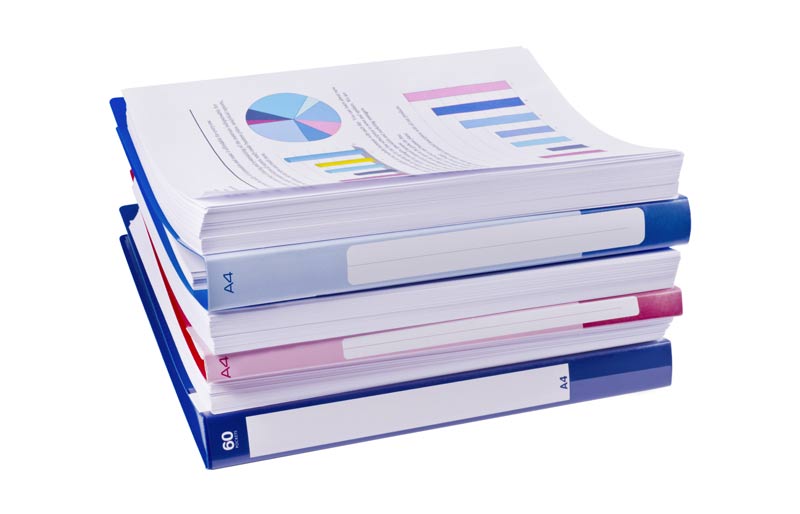 a pile of financial reports on a white background