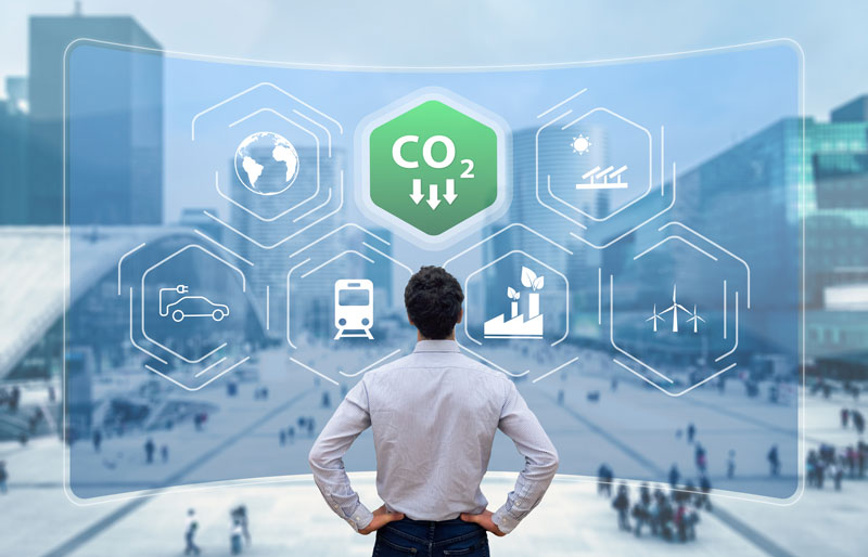 Businessperson standing in front of a screen displaying sustainable business icons.